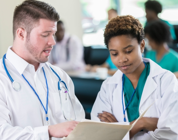 physician providing feedback to medical school resident